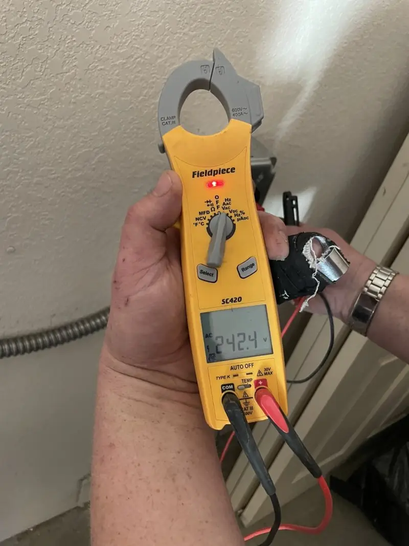 Voltage testing with clamp meter during Recessed Lighting Installation in Clay